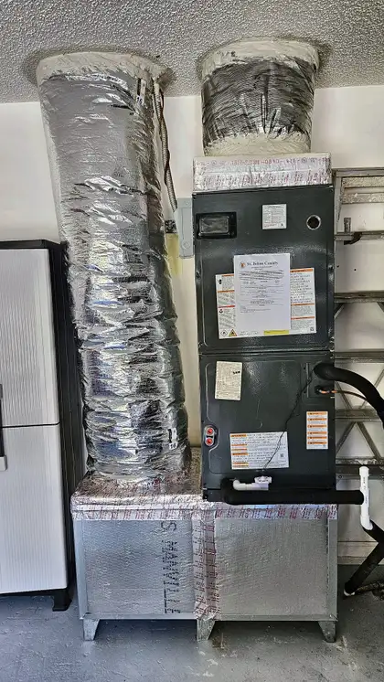 New air handler with insulated flex duct connections in a garage installation, St. Johns County FL
