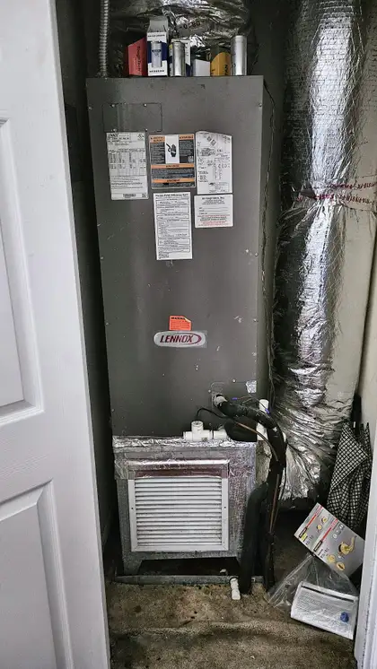Lennox air handler in a utility closet after service, Jacksonville FL