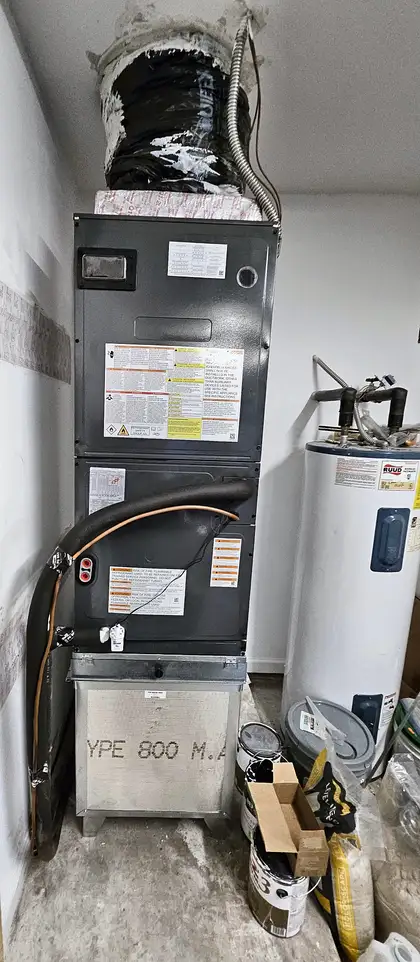 Air handler installed beside a water heater in an interior utility space, Jacksonville FL